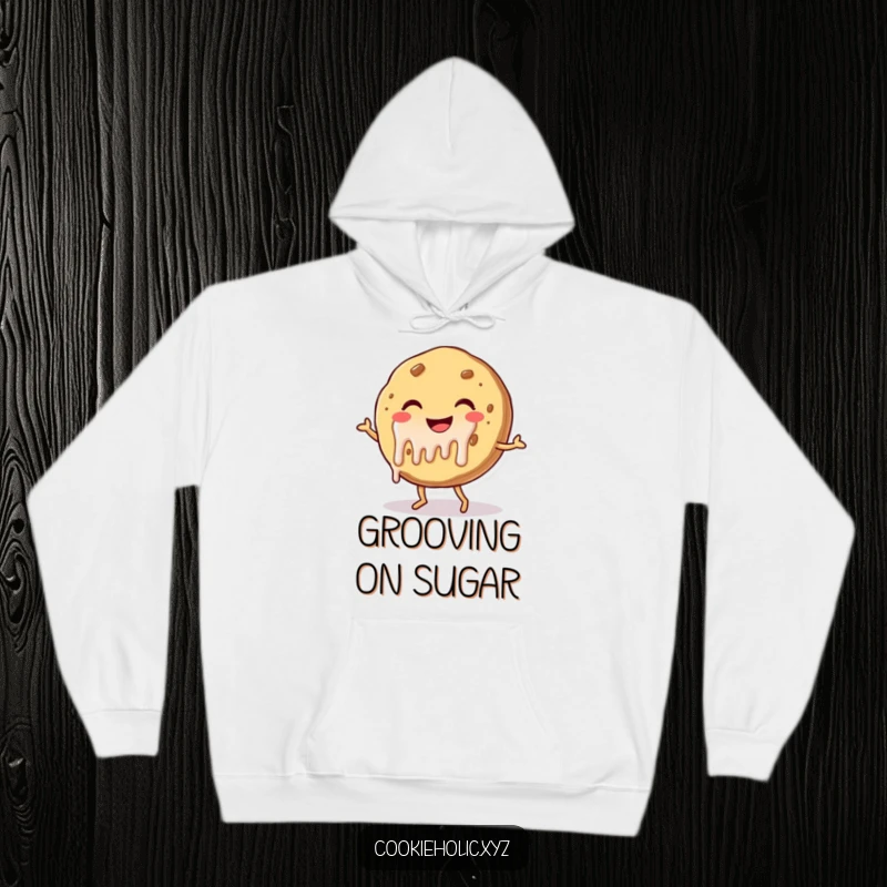 Funny hoodie depicting a smiling cookie character with frosting dripping, doing a joyful dance, offering cozy and humorous appeal.